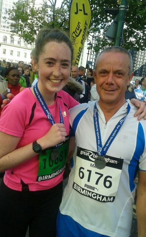 katie and her dad with medals after the birmingham half marathon